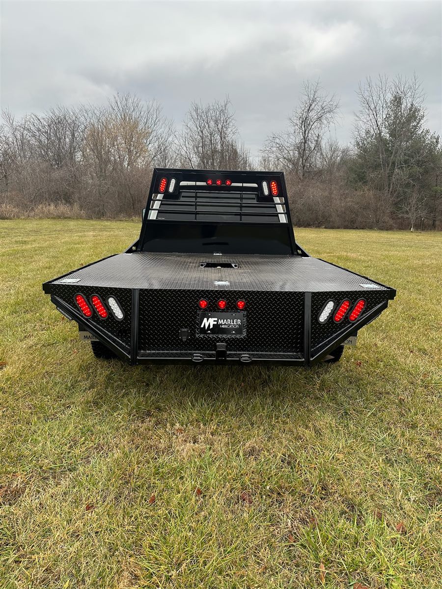 Rear of the flatbed with LED tail lights and a Marler Fabrication plate