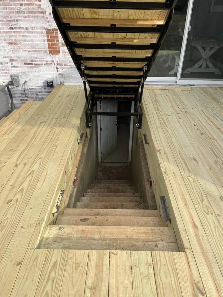 Looking down the stairs beneath the open hatch to the basement door