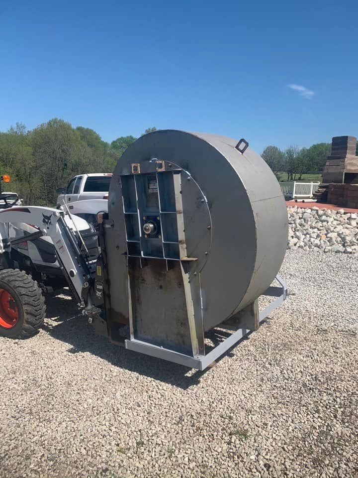 Side view of the blower mounted on a compact tractor