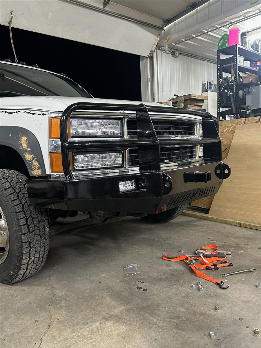 Angled view of the bumper showing the LED light, receiver hitch and shackle mounts