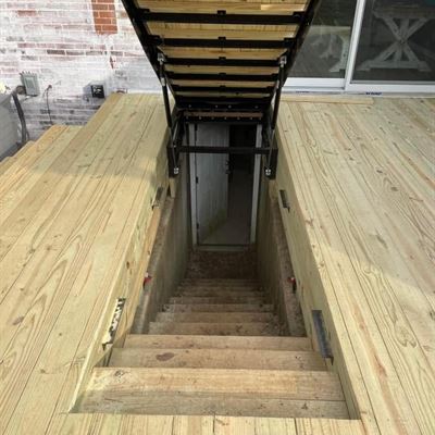 Looking down the stairs beneath the open hatch to the basement door