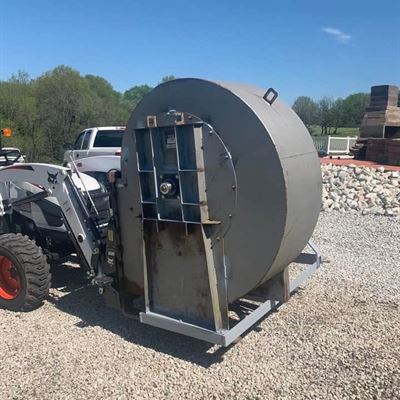 Side view of the blower mounted on a compact tractor