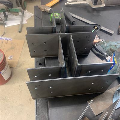 Custom steel post brackets being welded