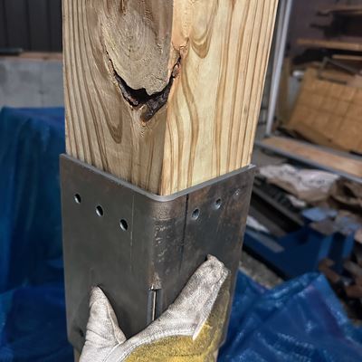 Steel post sleeve fitted on a wood post