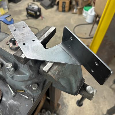 Bent steel bracket in the vise