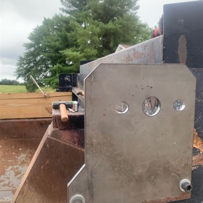 Custom steel bracket on a dump truck bed