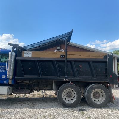 Dump truck with the tarp arm raised