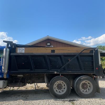 Dump truck with tarp arms installed