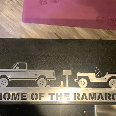 Home of the Ramaro sign with truck and Jeep cutouts