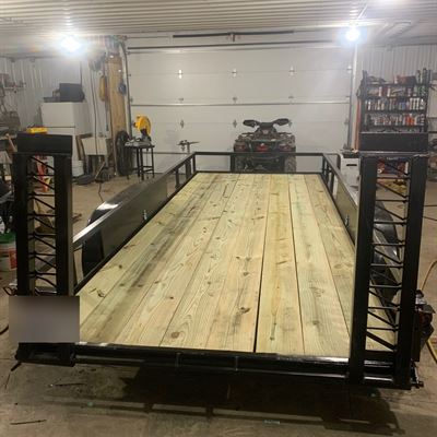 Finished utility trailer with a new wood deck and ramp gate