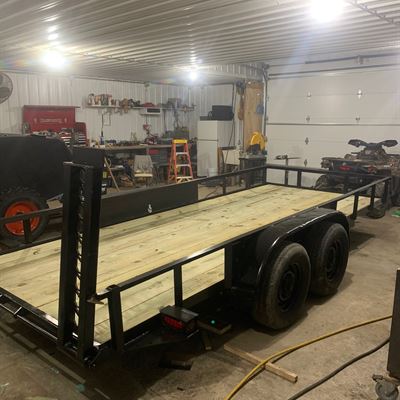 Finished tandem-axle utility trailer with a wood deck