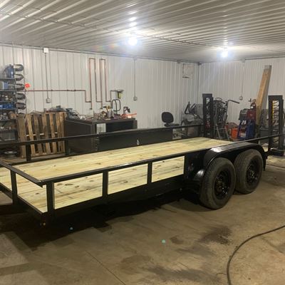 Utility trailer with wood deck and side rails