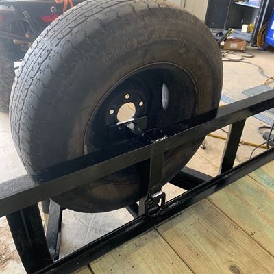 Spare tire mount on a trailer side rail