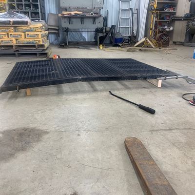 Expanded metal trailer ramp gate in the shop
