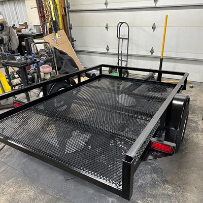 Small utility trailer with an expanded metal floor